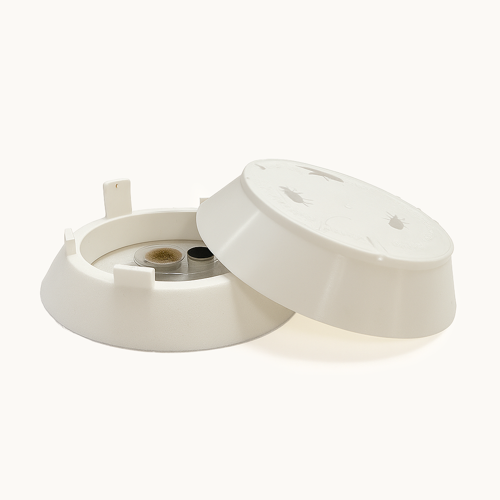Xlure FIT Fabric Insect Trap with lid open, showing cartridge inside a white plastic housing.