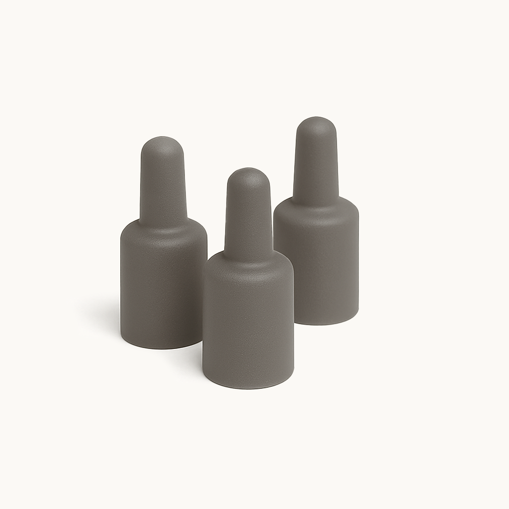 Three grey pheromone lure capsules arranged on a clean white background, representing a pack of universal moth pheromone refills.